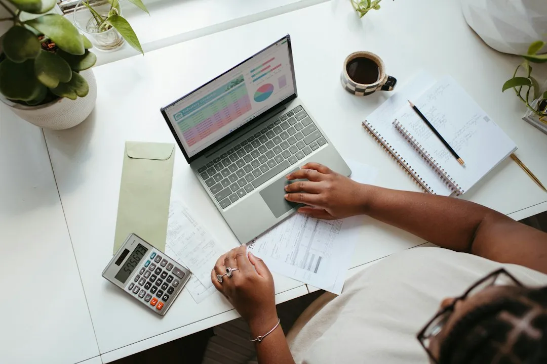 Woman business owner reviewing financial planning calendar and deadline countdown at her desk