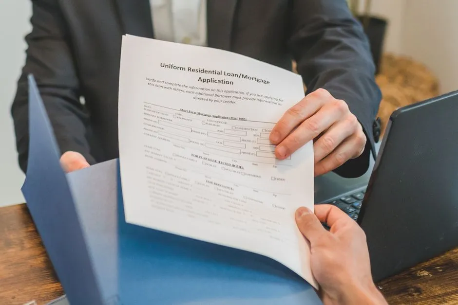 Organized loan application documents and financial folders for SBA preparation