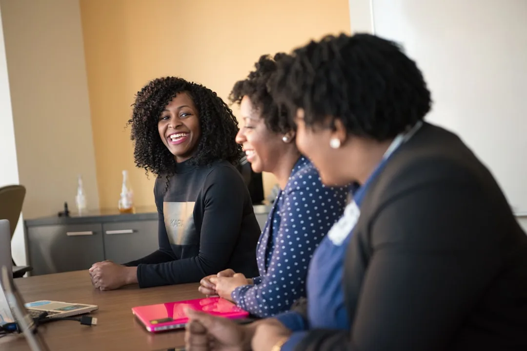 Woman business owner meeting with a community lender in a warm office setting