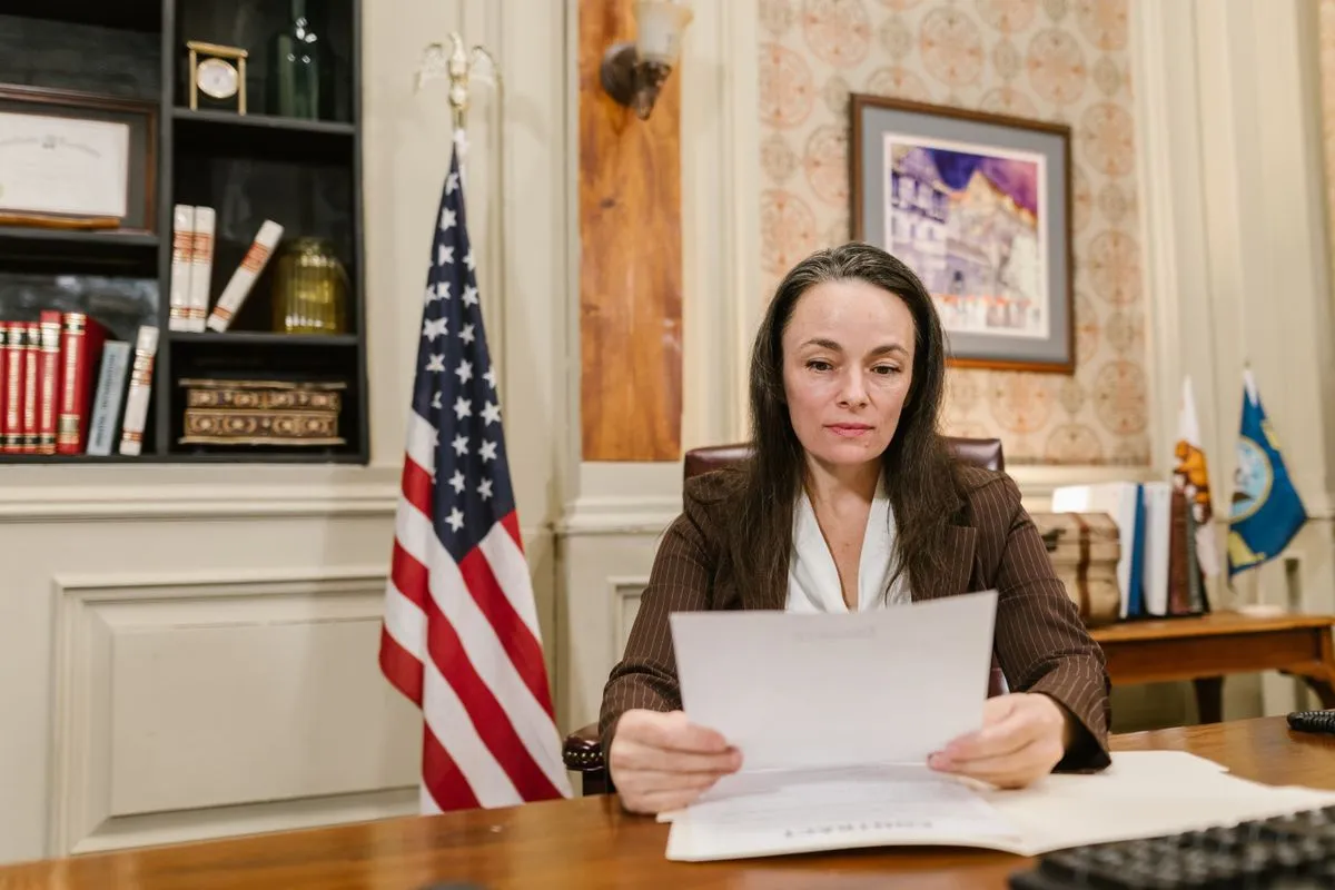 Woman reviewing government regulatory documents at desk