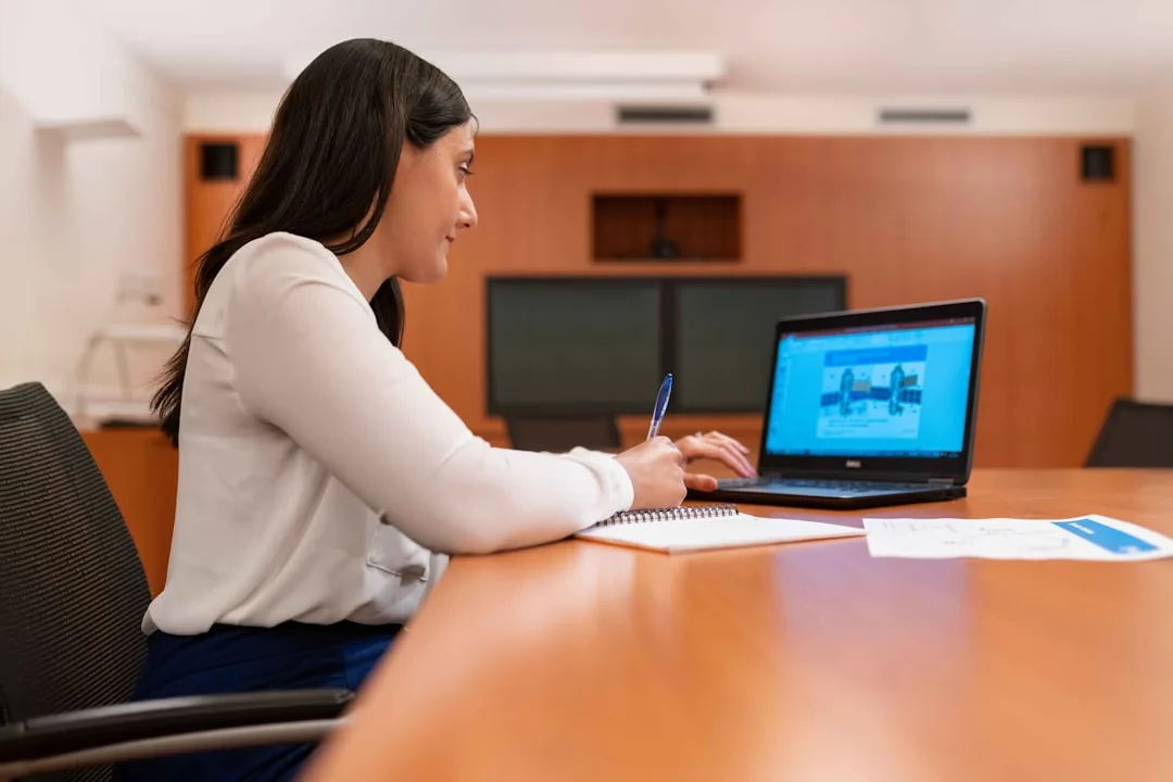 Professional woman analyzing financial data on a laptop in a modern office