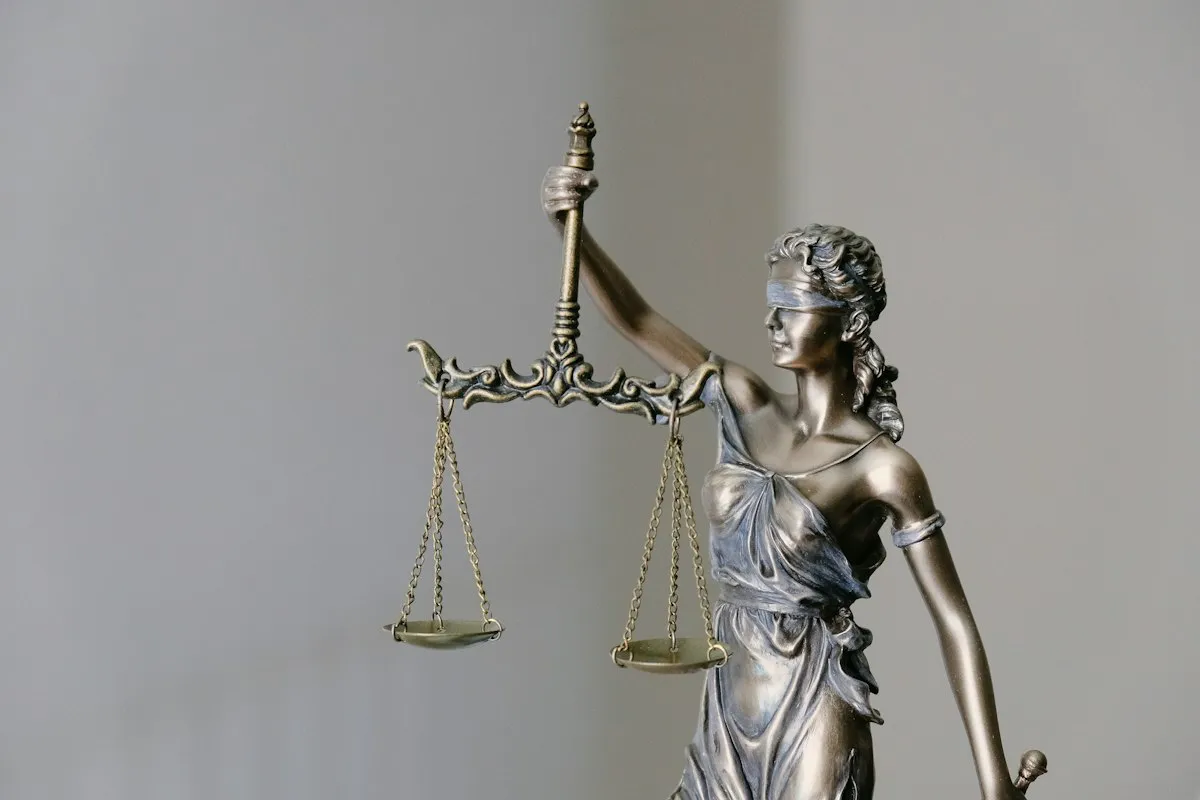 Lady justice statue with scales, symbolizing unequal lending standards