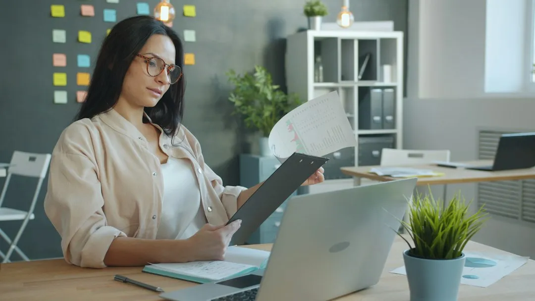 Woman working with documents at office desk planning for deadlines
