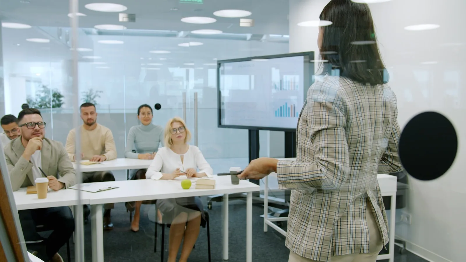 Woman presenting to investors in a boardroom setting