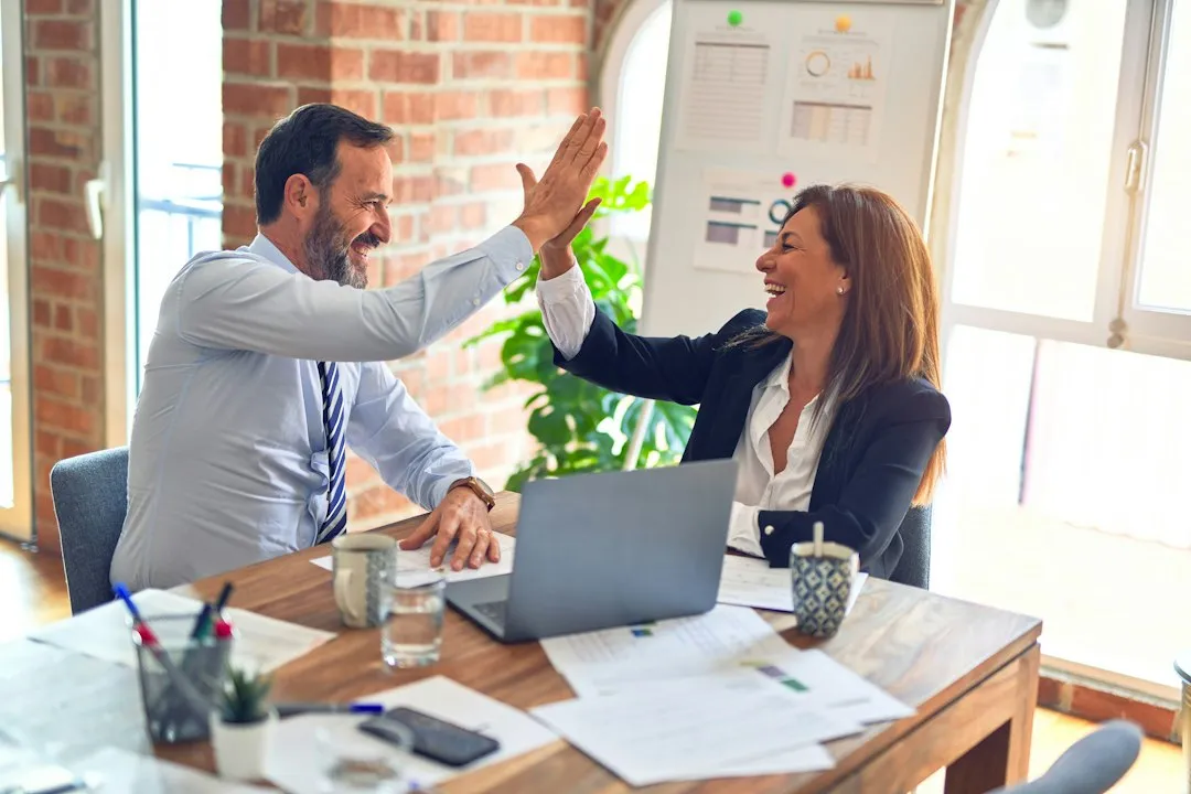 Business meeting between woman entrepreneur and banker discussing loan terms