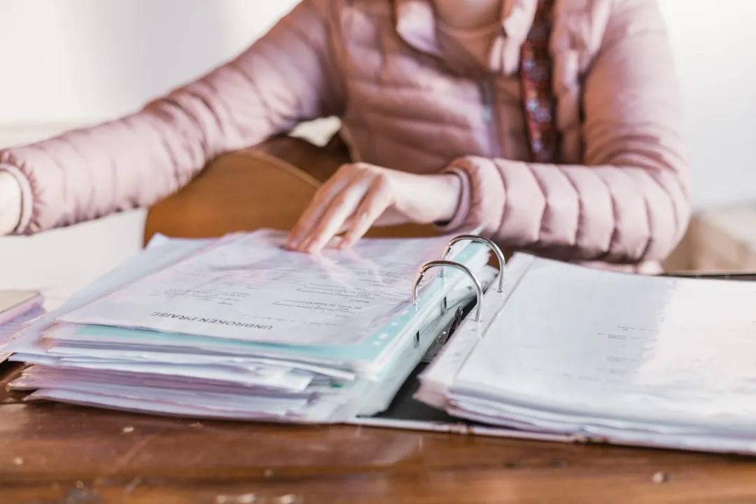 Woman at desk with documents looking frustrated
