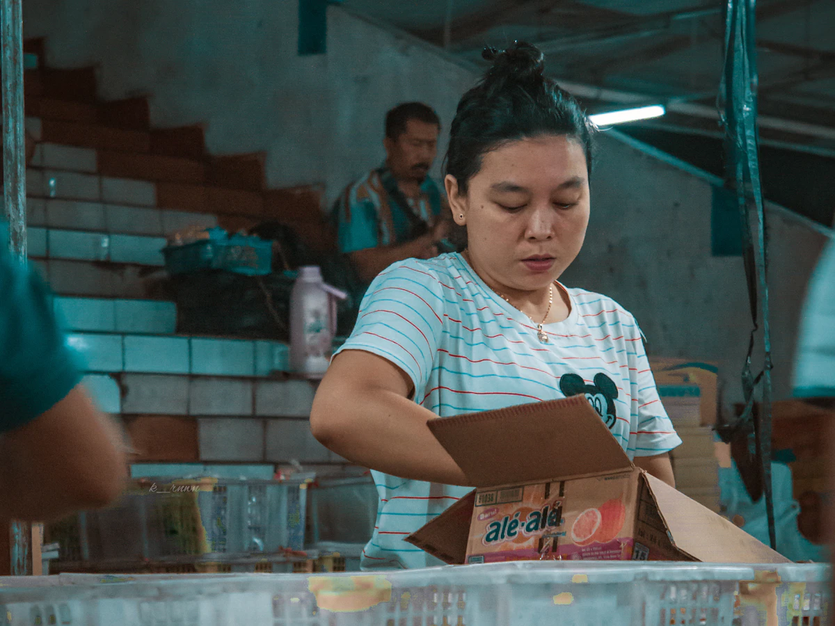 Woman small business owner packaging handmade products for shipping